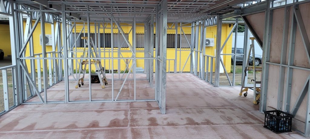 Framed interior of a modular steel building during construction