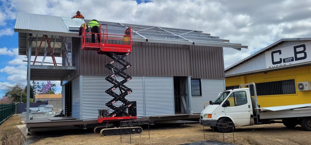 Roof cladding installation on a two-storey modular steel building