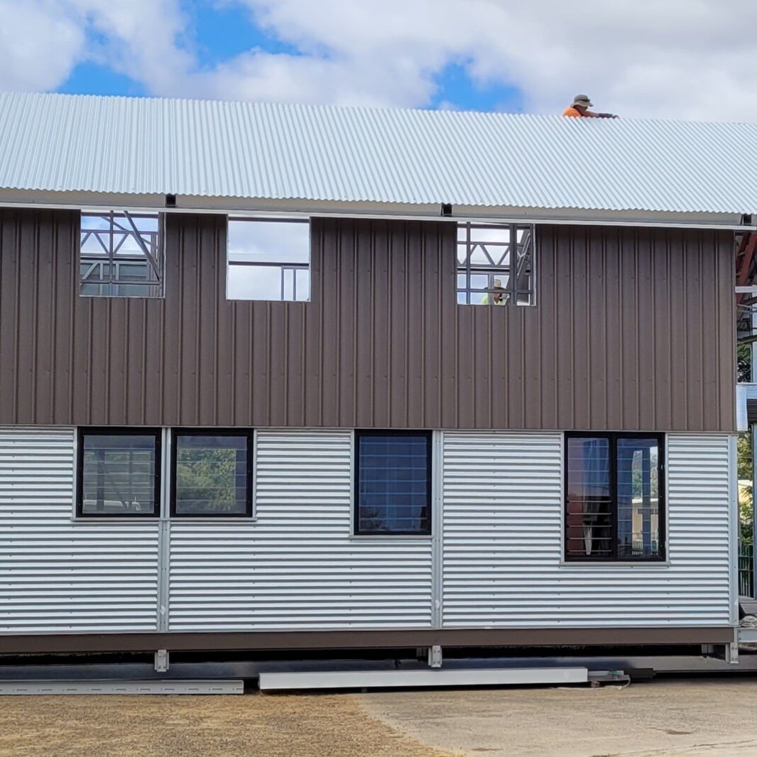 Two-storey modular steel building with roof and exterior cladding installed