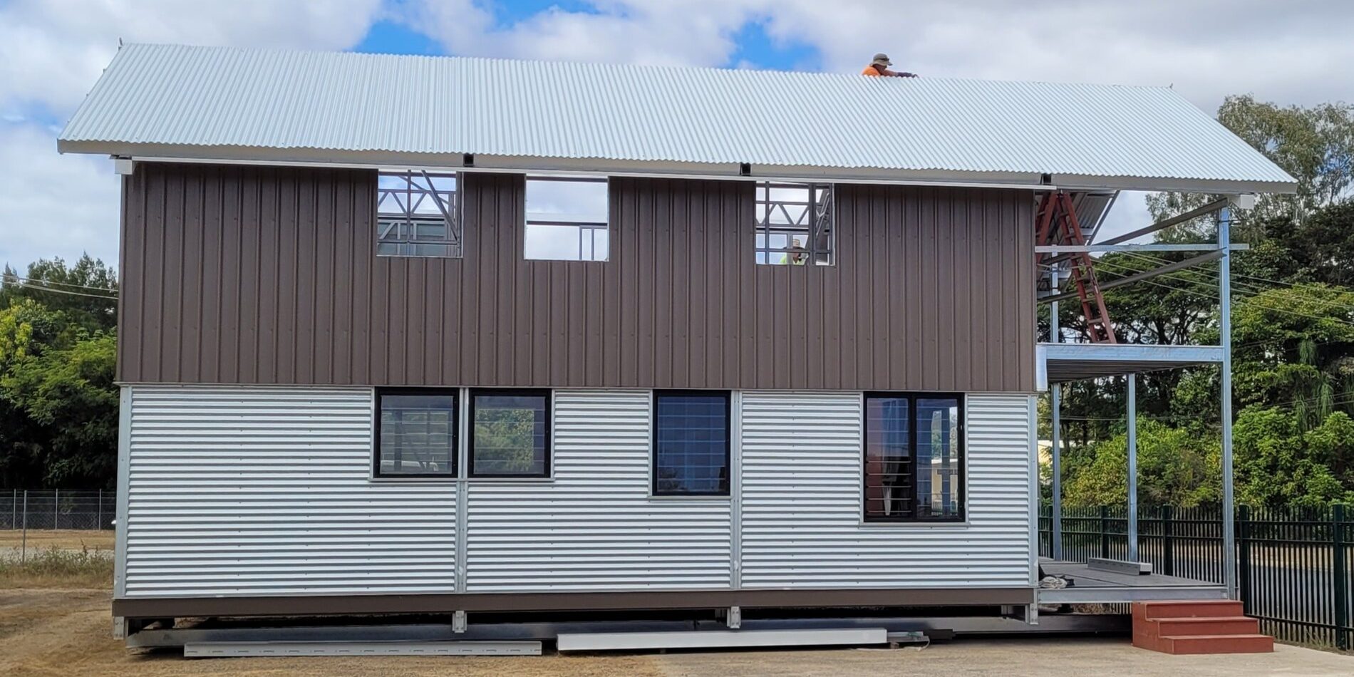 Two-storey modular steel building with roof and exterior cladding installed